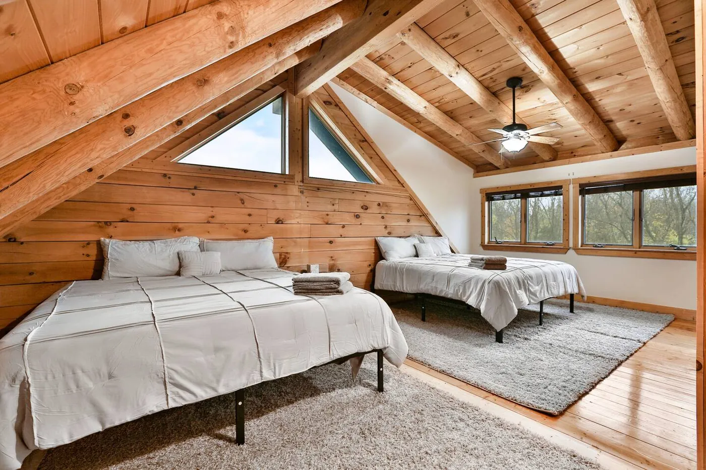 Upper-level room with a king bed and a single bed under the roofline