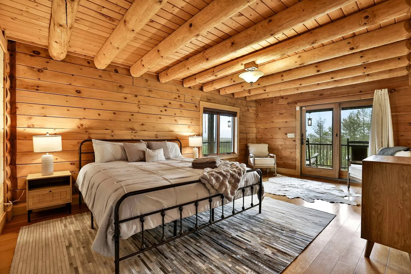 King suite with log beams and balcony doors