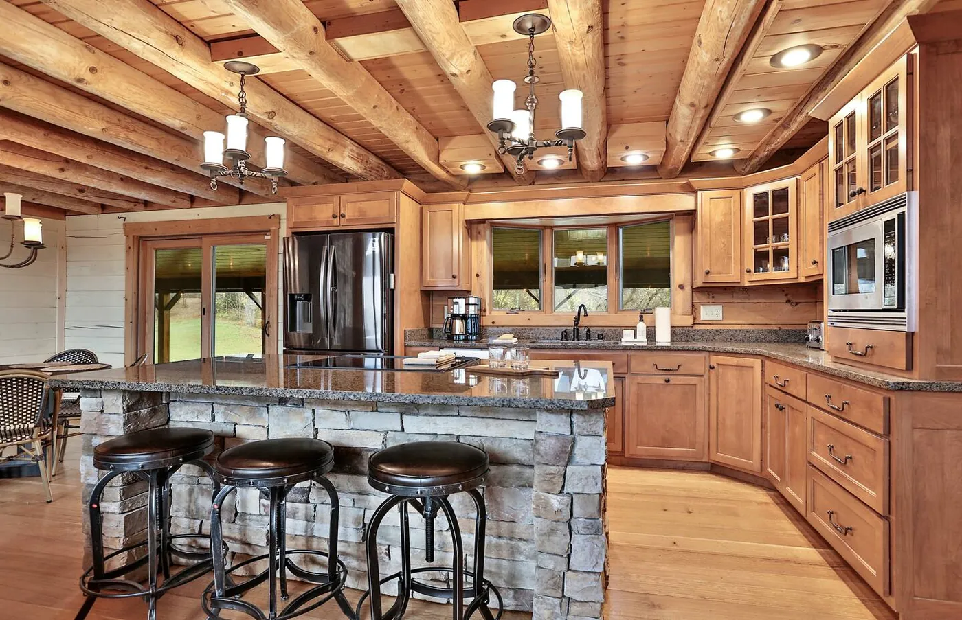 Kitchen with stone island and bar stools